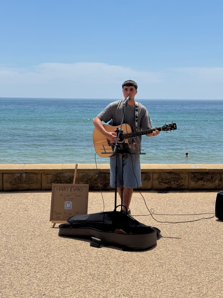 Harry Evans Live on the Terrigal walk playing guitar and singing in the sun Central Coast NSW Australia